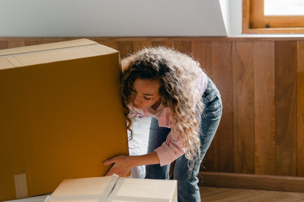 Woman lifting a cardboard box