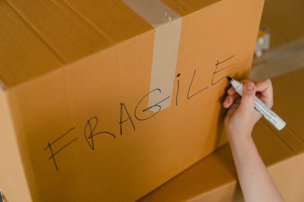 Cardboard box with the word “fragile” written across it.