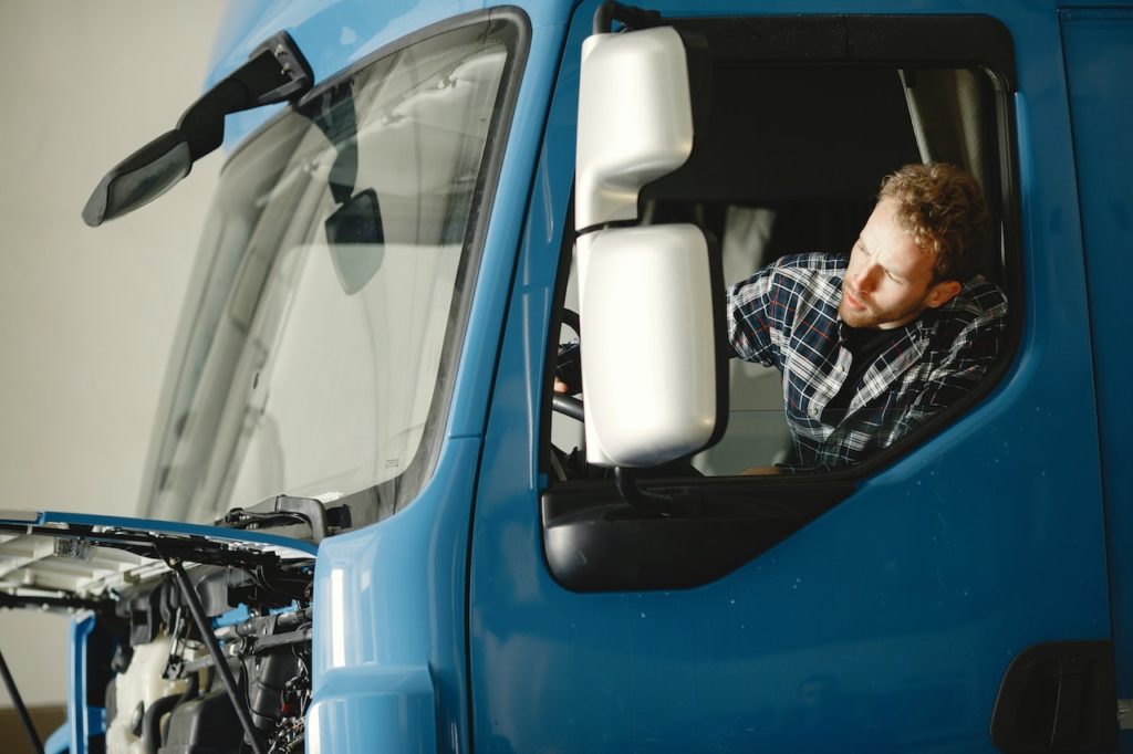 A truck driver looking out from his truck window